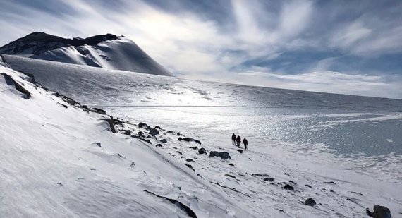 Scientists walking across a glacier